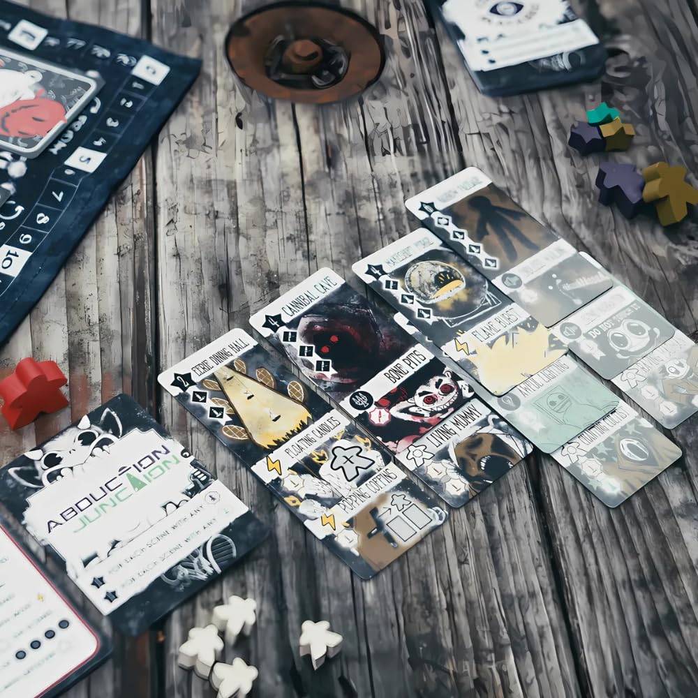 Horror-themed board game cards featuring titles like Cannibal Cave and Bone Pits are displayed alongside white and colored wooden player tokens
