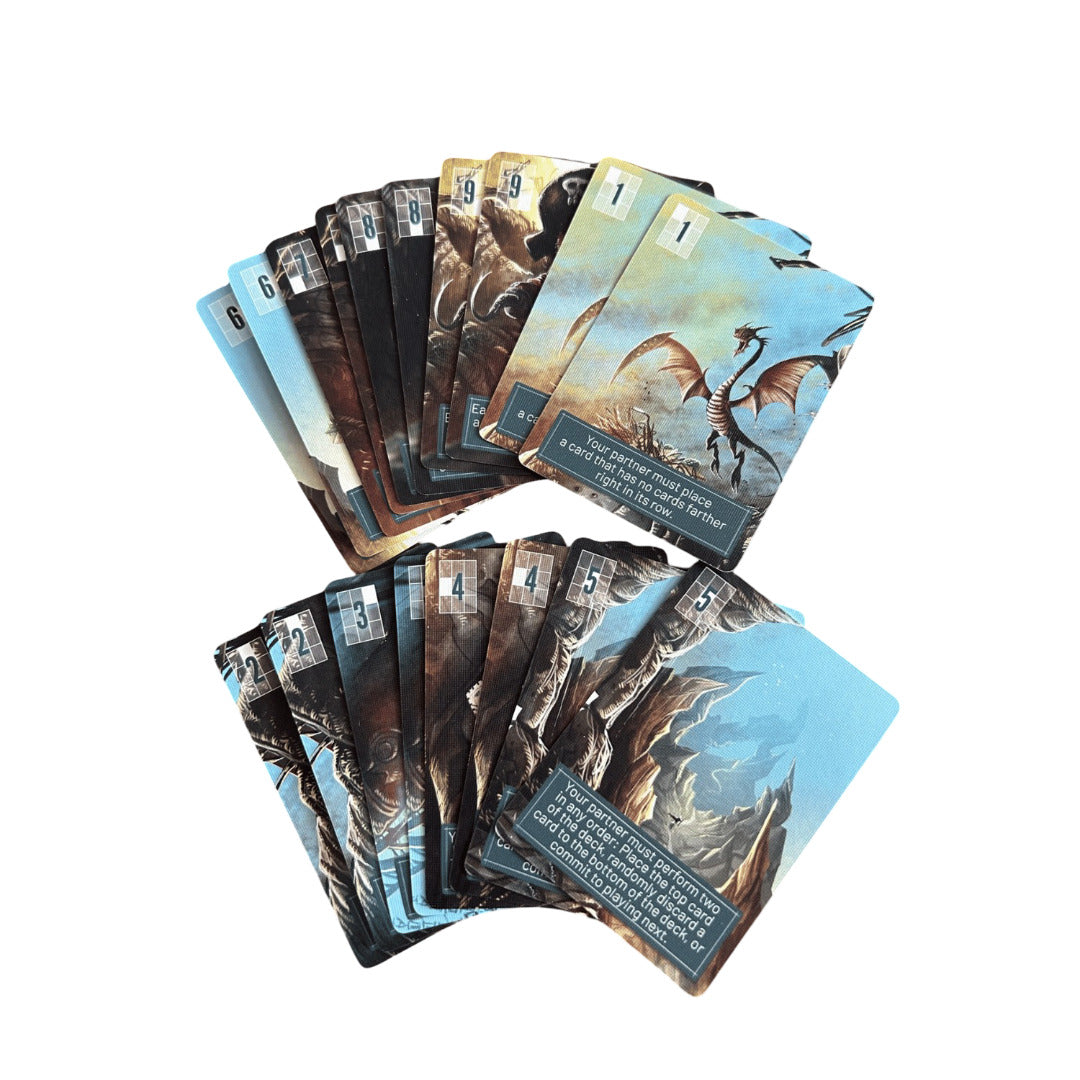 Two fanned stacks of fantasy-themed game cards featuring illustrated dragons and numbered corners are displayed against a clean white background