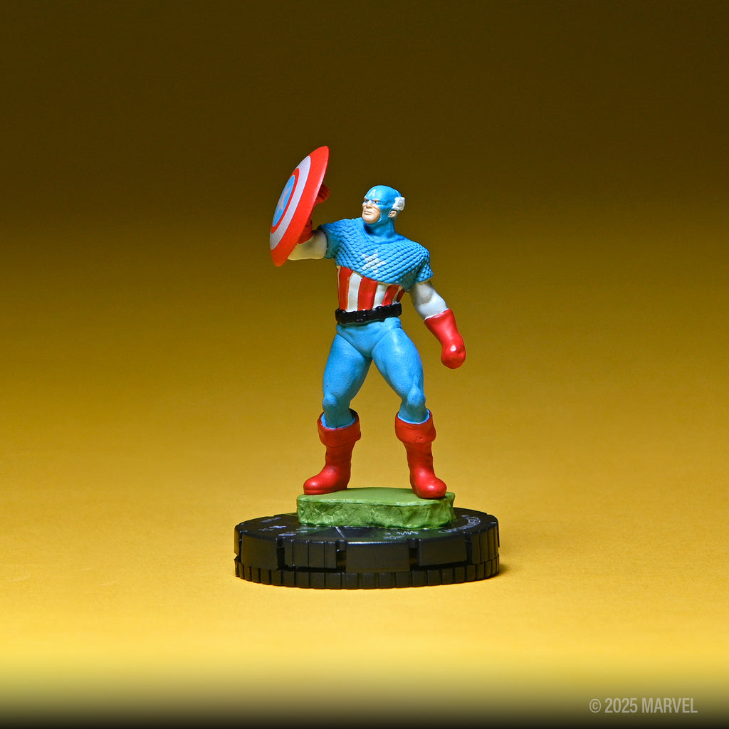 Captain America miniature in blue uniform holding iconic shield defensively