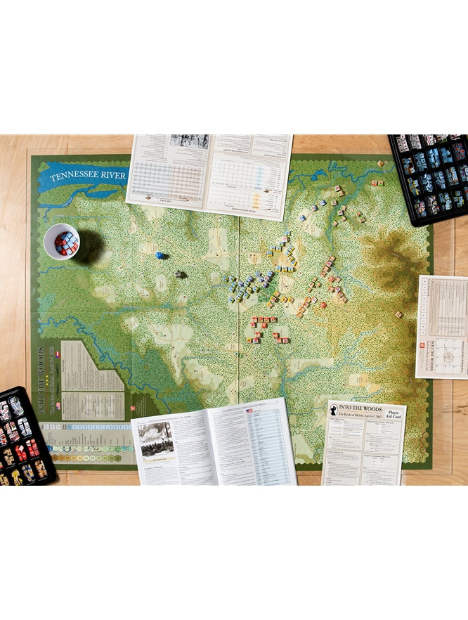 Overhead shot of "Into the Woods: Battle of Shiloh" wargame set up, showing map, game pieces, rulebooks and aids
