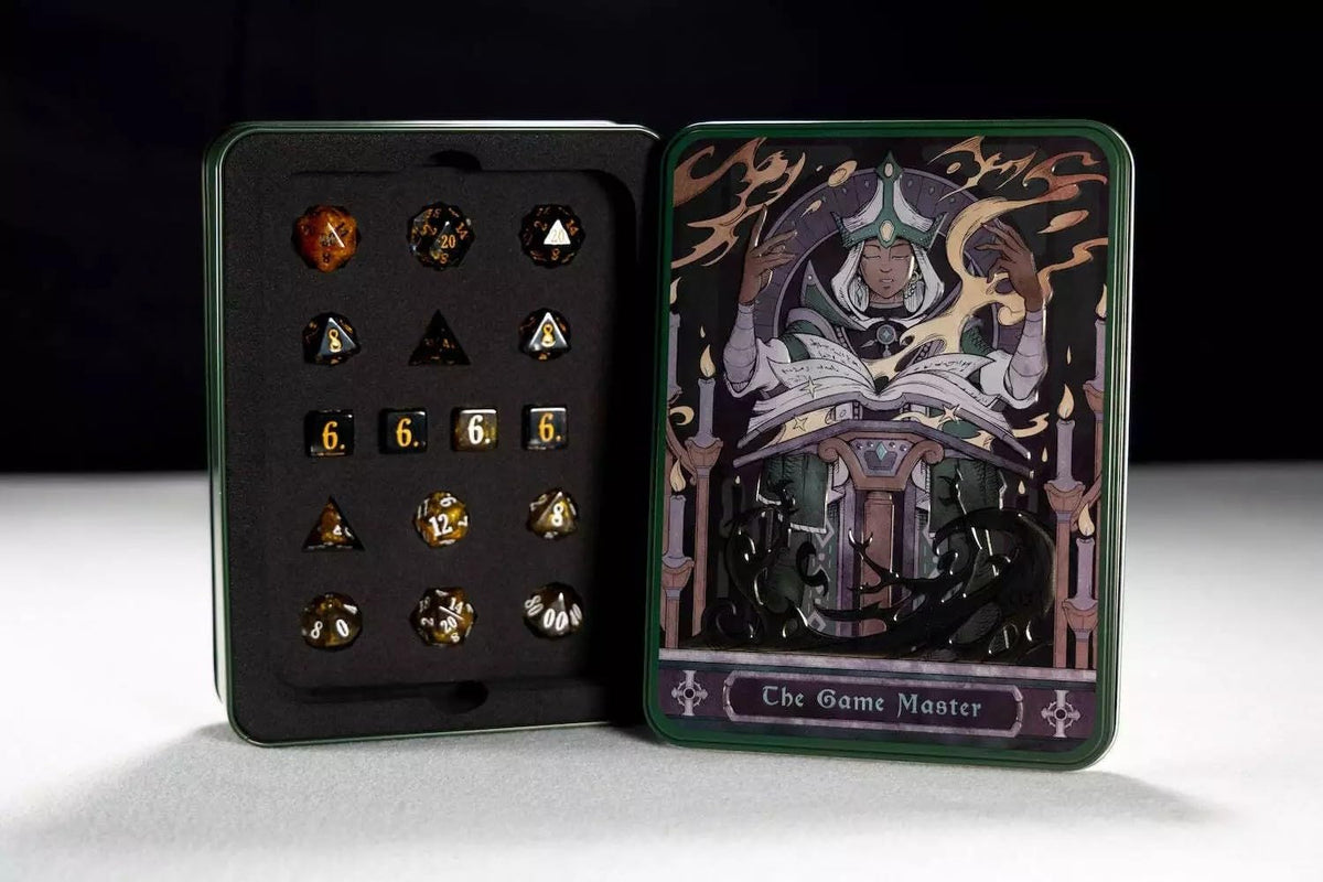 An open tin box reveals a set of polyhedral dice on the left and an illustrated lid labeled The Game Master on the right