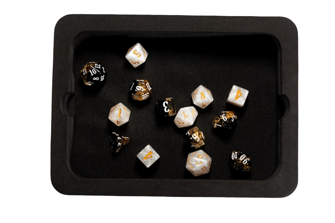 A black rolling tray holds an Epic Character Class Dice Set - The Cleric, featuring several white and black polyhedral dice with gold numbers