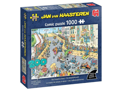 A blue boxed 1000 piece Jan van Haasteren Comic puzzle depicting The Soapbox Race, showing a busy cartoon illustration of soapbox carts crashing down a crowded street filled with spectators