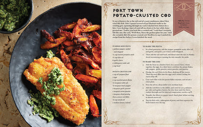 An open spread from Insight Editions Diablo The Official Cookbook features golden potato-crusted cod with green pesto and roasted potatoes on a black plate with the recipe details