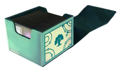The open Domaru deck box in mint green leatherette is filled with dark sleeved cards, displaying a teal graphic of a stylized tree symbol on the front panel