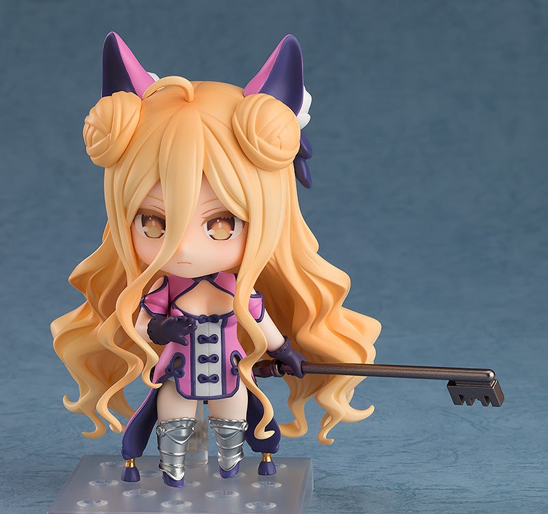 Chibi anime figurine with blonde hair pink dress and purple accents holding a large key