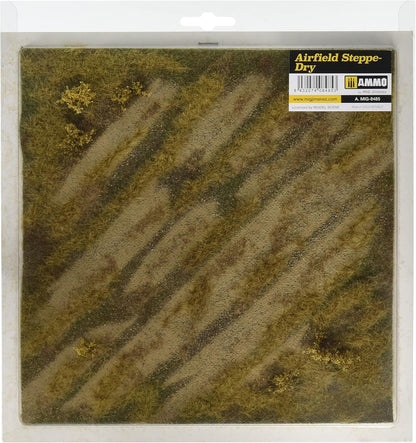 A packaged 'Airfield Steppe-Dry' model terrain mat with dry grass, diagonal dirt paths, and yellow shrubs.