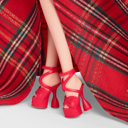Doll's legs in a sparkly red tartan dress and red platform high heels with ankle straps