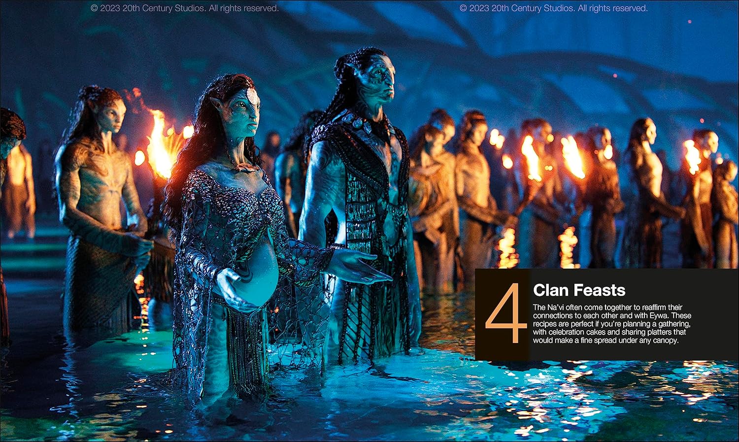 Pregnant Na'vi woman and man stand in bioluminescent water -  surrounded by others holding torches at a night ritual