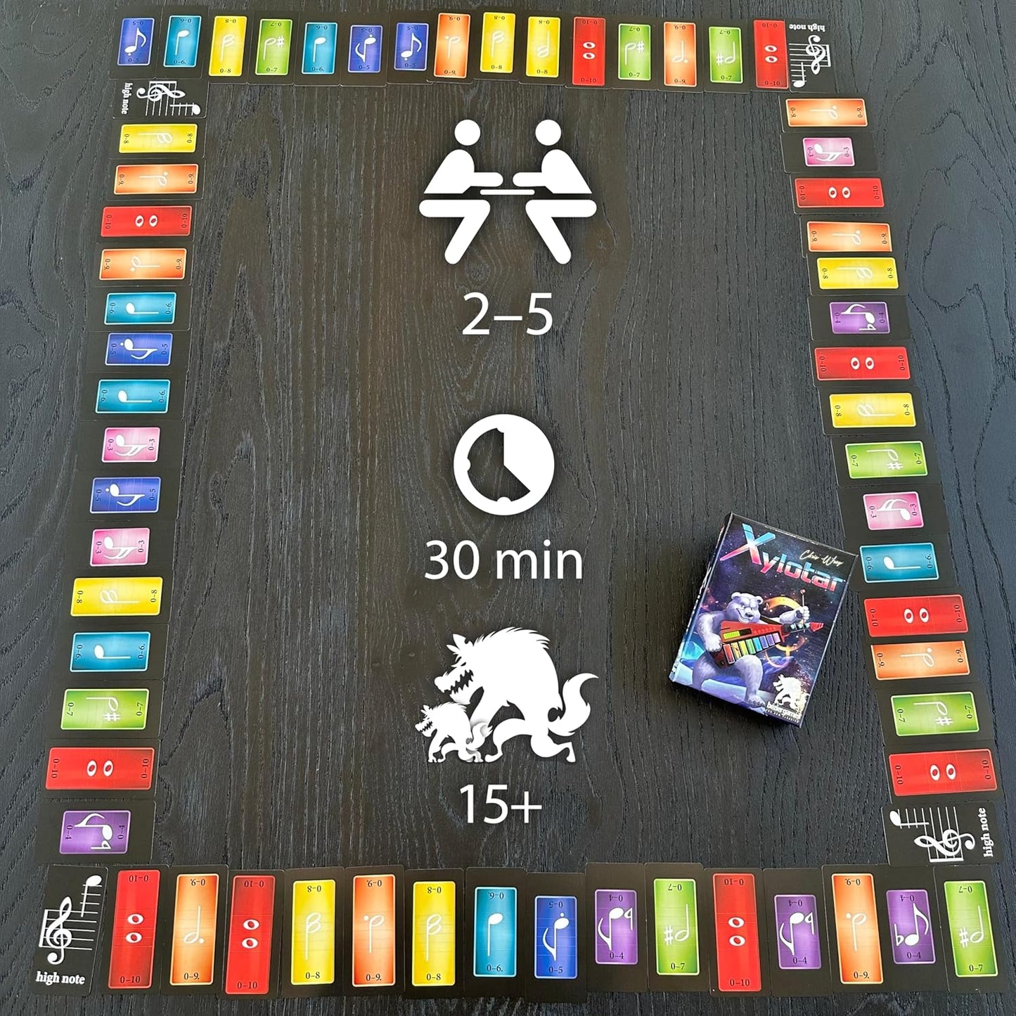 Xylotar board game on a table: a path of colorful musical note cards surrounds game player/time info.