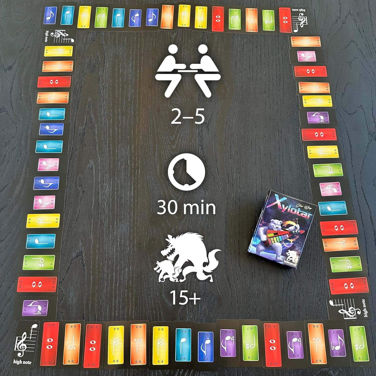 Xylotar board game on a table: a path of colorful musical note cards surrounds game player/time info.