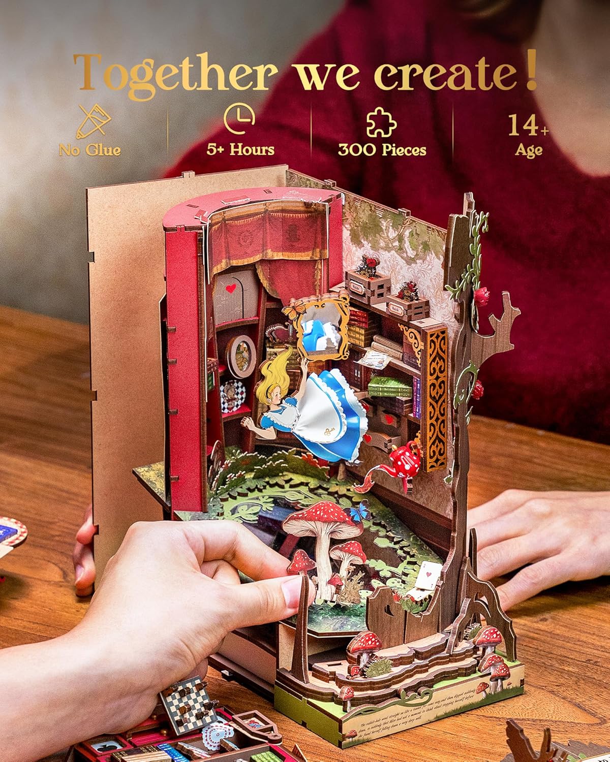 Hand assembling a detailed Alice in Wonderland 3D wooden book nook puzzle featuring mushrooms