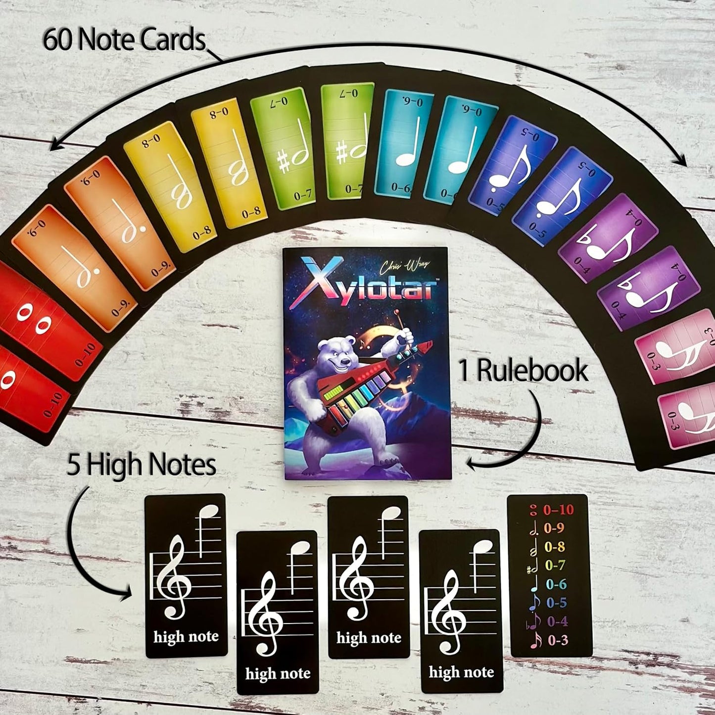 Xylotar game on wood: rulebook showing polar bear playing, 60 colorful musical note cards, 5 high note cards.