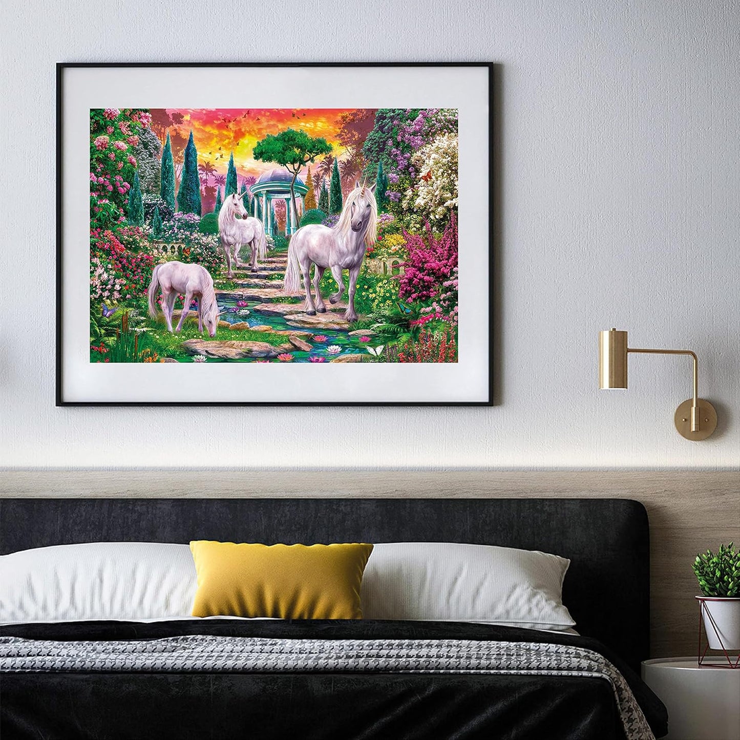 Painting of three white unicorns in a vibrant fantasy garden under a sunset sky, hanging above a bed