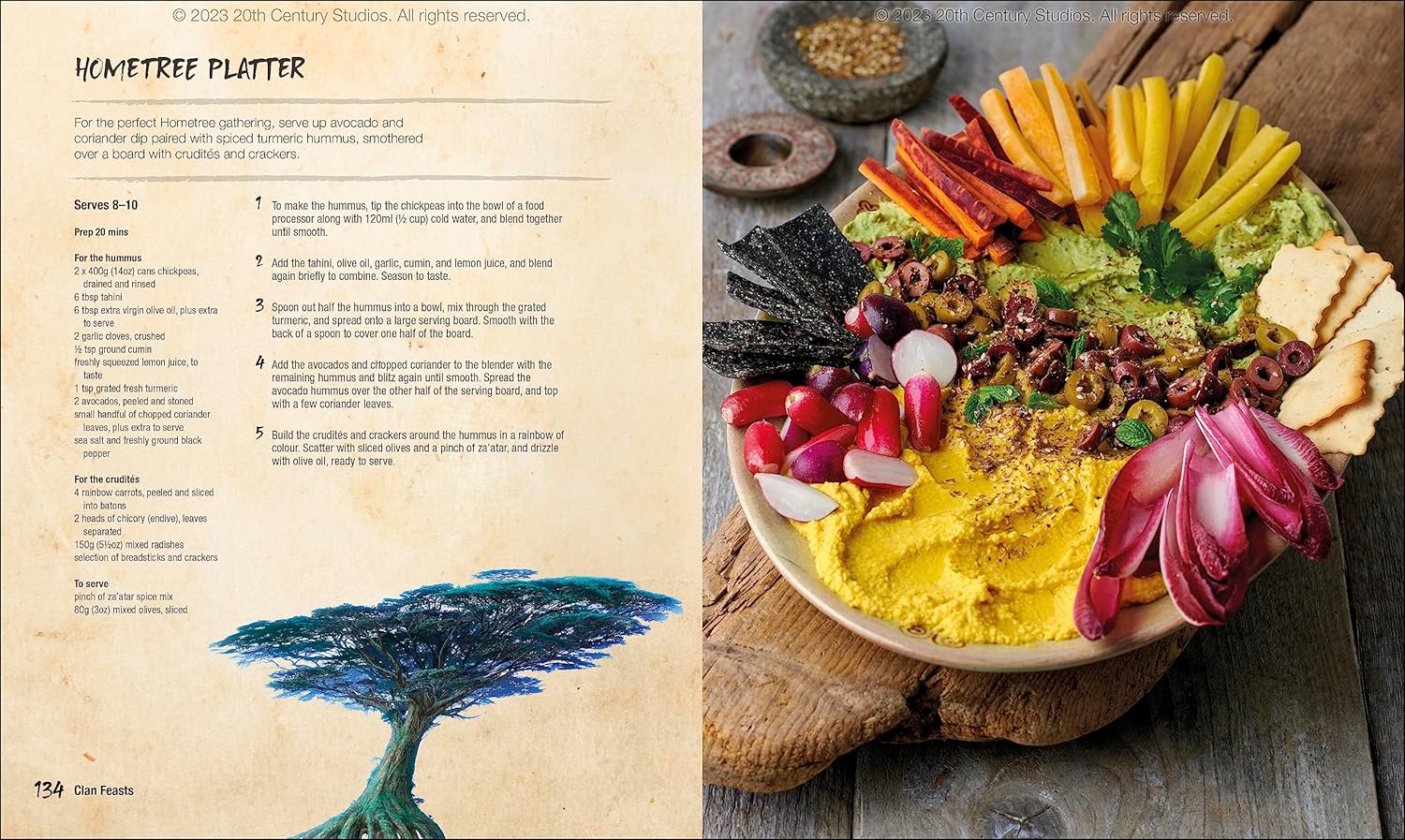 A vibrant Hometree Platter with yellow hummus -  green dip -  various crudits -  olives -  and crackers on wood
