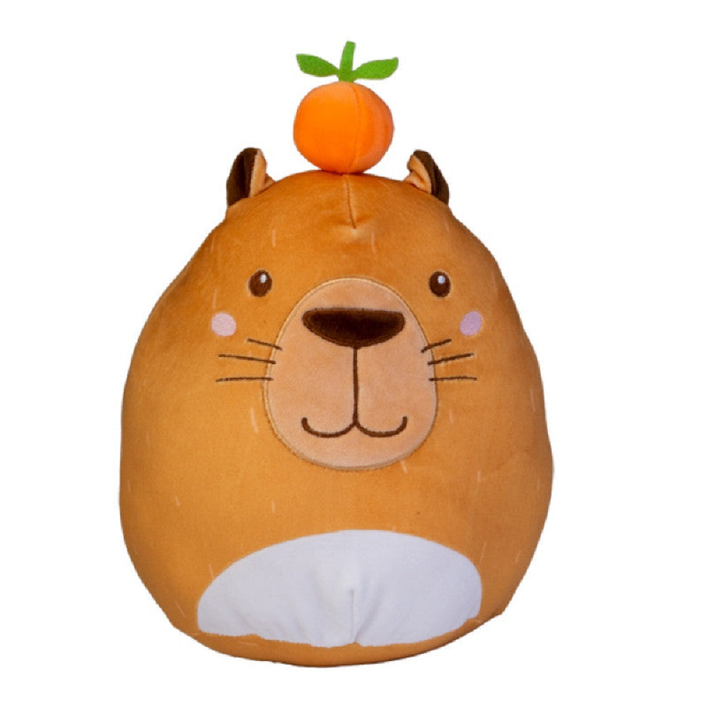 Close-up of a rounded Smooshos Pal Capybara plush toy, featuring a fuzzy orange exterior, white belly, and a small plush orange fruit accessory perched on its head