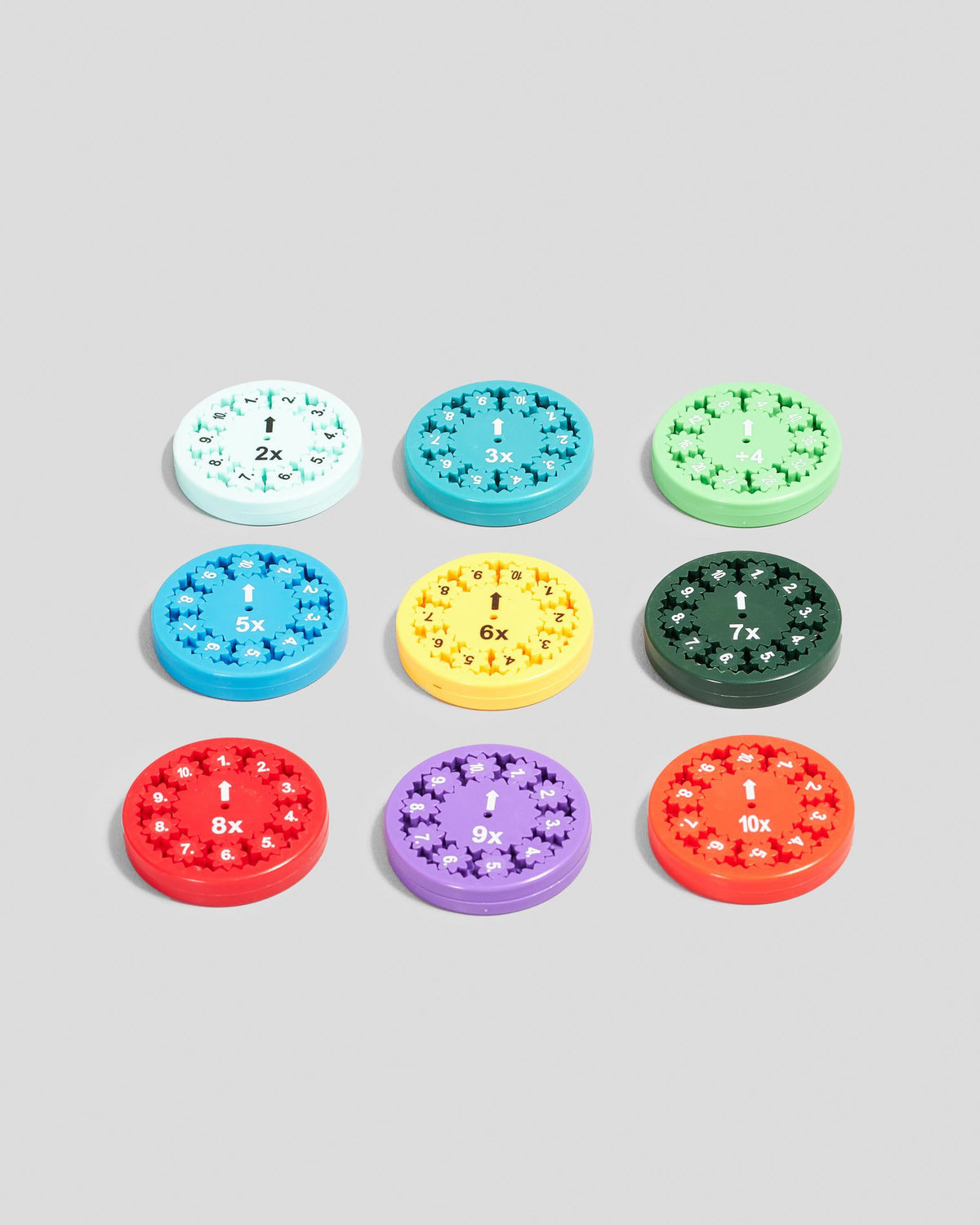 Nine colorful circular math toys with numbers and symbols arranged in a grid
