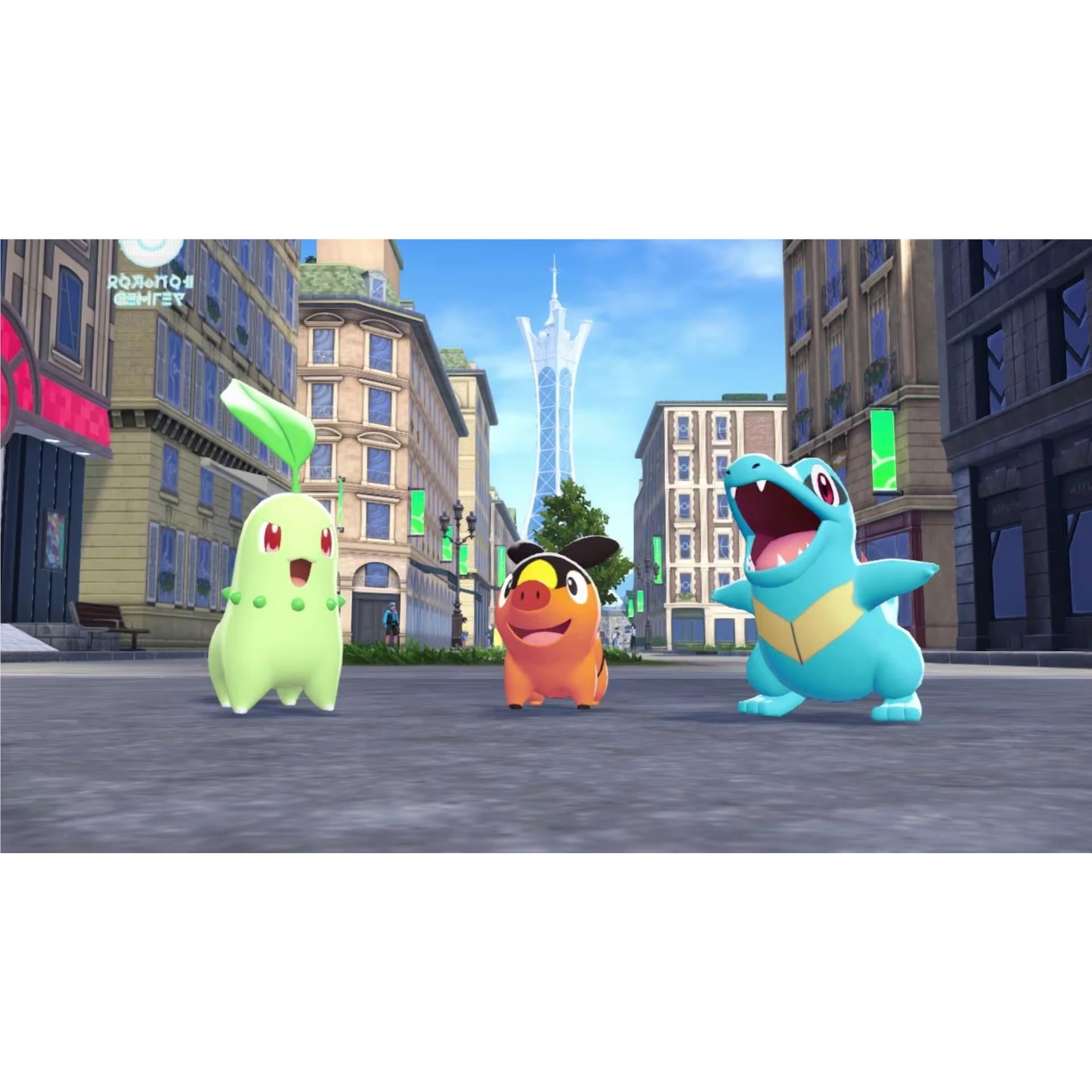 Three Pokémon, Chikorita, Tepig, and Totodile, stand prominently on a paved city street beneath a striking futuristic tower structure