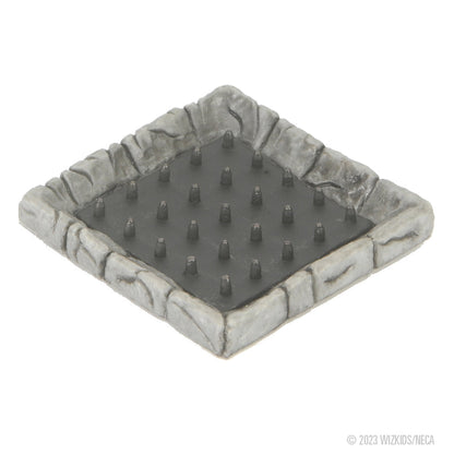 A miniature square grey stone dungeon tile with a dark, spiked floor, depicting a spike trap