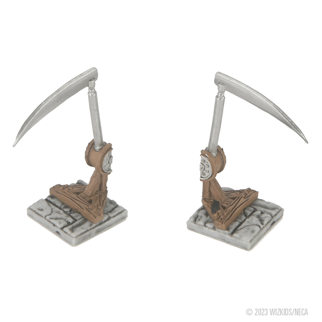 Two identical miniature scythe traps, with silver blades, brown mechanisms, and grey stone bases