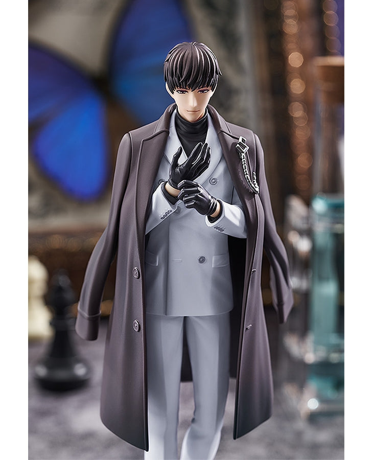 Anime figure of a man in a charcoal trench coat light grey suit black turtleneck and black gloves