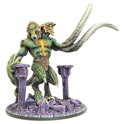 A green-skinned, two-headed Demon Lord Demogorgon miniature with lion and reptilian heads, scaled legs, and two long tentacles stands on a base of broken purple pillars