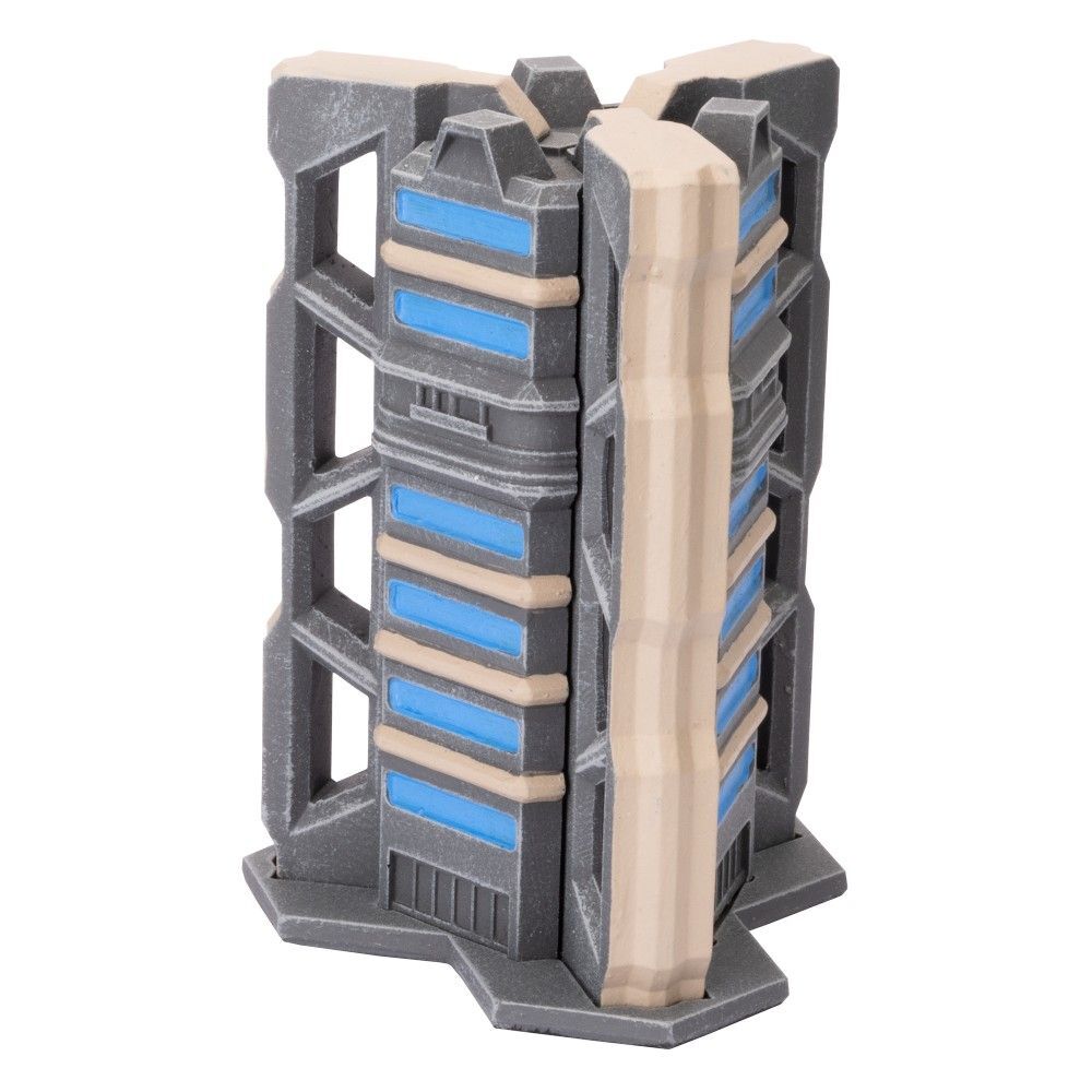 A Trinity City Tri-Tower miniature terrain piece, a grey futuristic building with three angled sides, blue recessed windows, and beige vertical accents