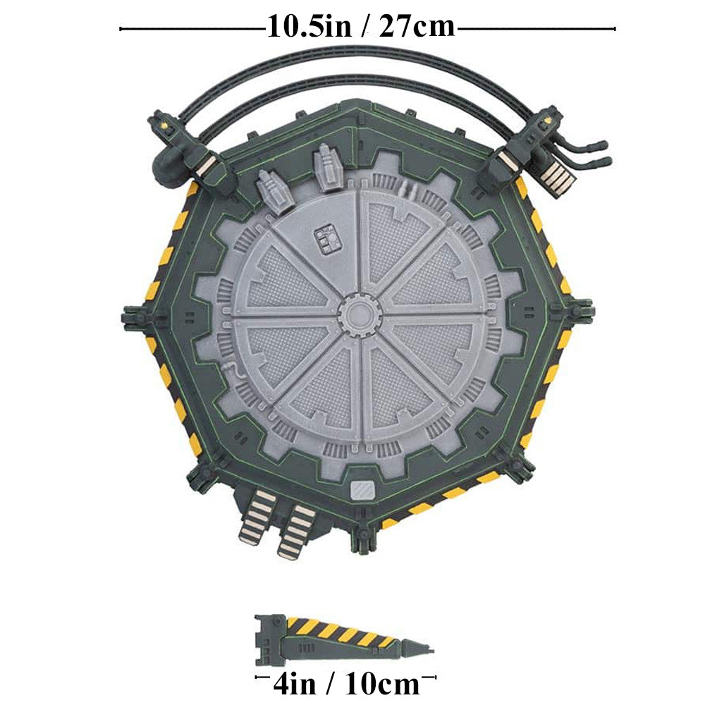 A dark green hexagonal sci-fi terrain piece with a segmented grey circular center, yellow hazard stripes on the edges, and a smaller matching wedge piece