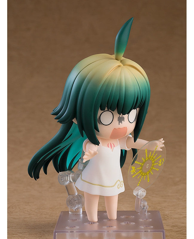 Nendoroid figure with teal and yellow hair wide-eyed shocked expression wearing white dress with gold trim holding transparent prop
