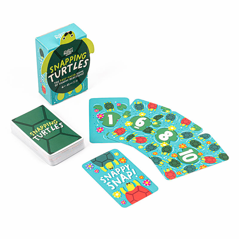 Professor Puzzle's Snapping Turtles card game box, deck, and scattered numbered playing cards with turtle illustrations