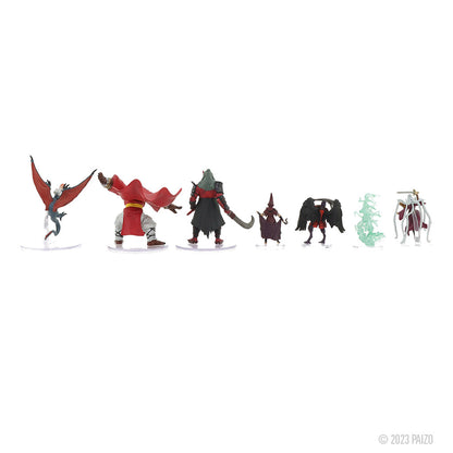 A line of seven diverse fantasy miniatures: creatures, warriors, and magic-users