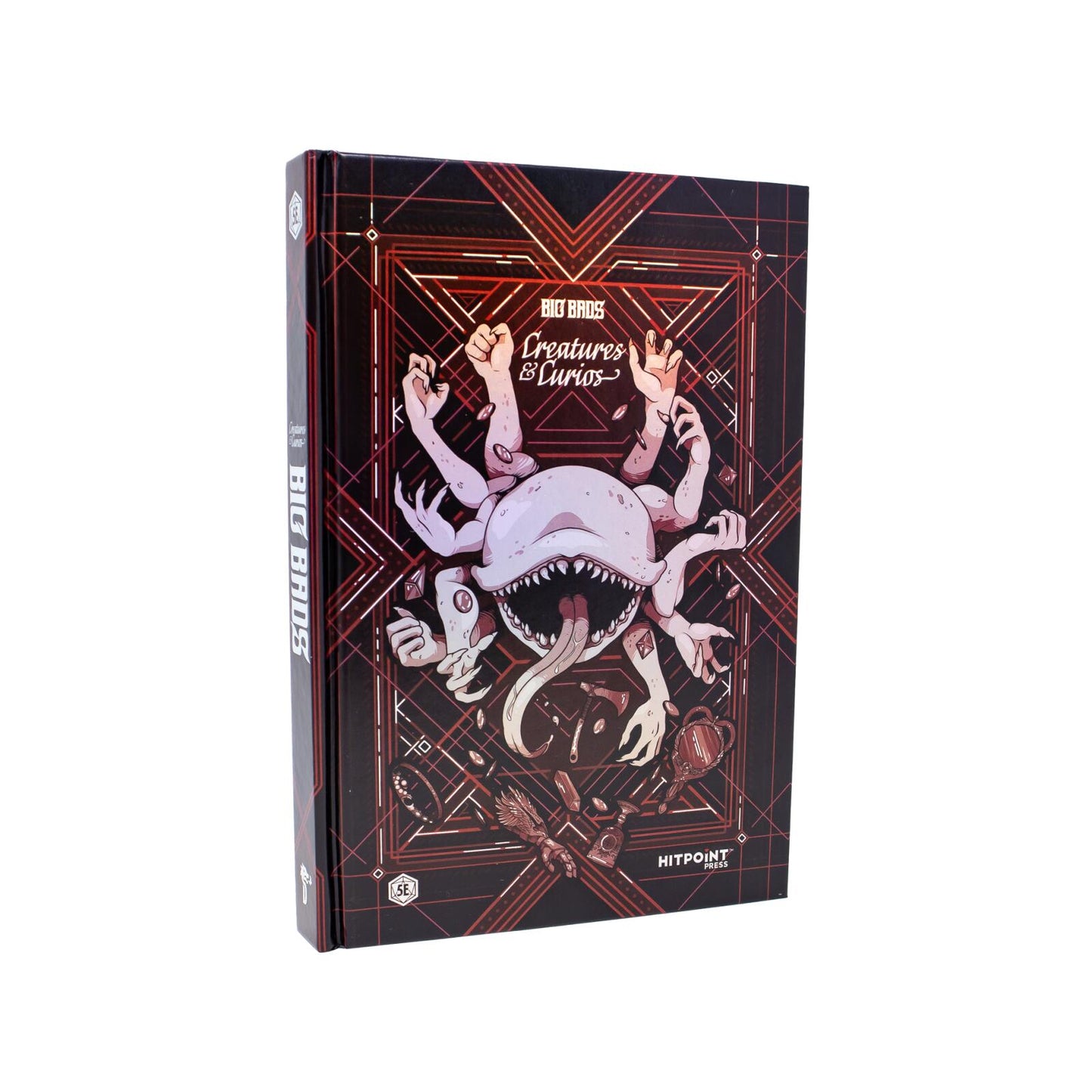 A hardcover Big Bads Creatures & Curios book with a dark cover showing a multi-limbed monster, open mouth, long tongue, and scattered magical items
