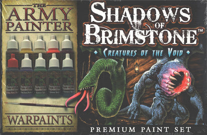 A Shadows of Brimstone Creatures of the Void Premium Paint Set box showing 10 paint bottles, a paintbrush, and two monsters: a green worm and a grey beast with a chest mouth