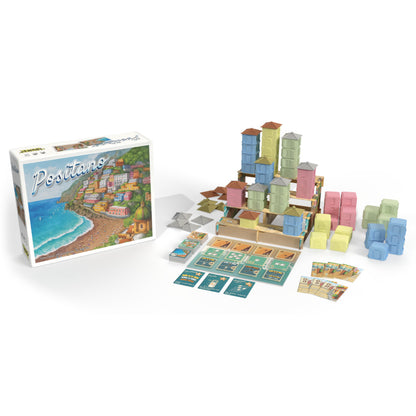 Positano board game box displayed beside all components including cards, cardboard terrain, and stacks of colorful tiered building pieces
