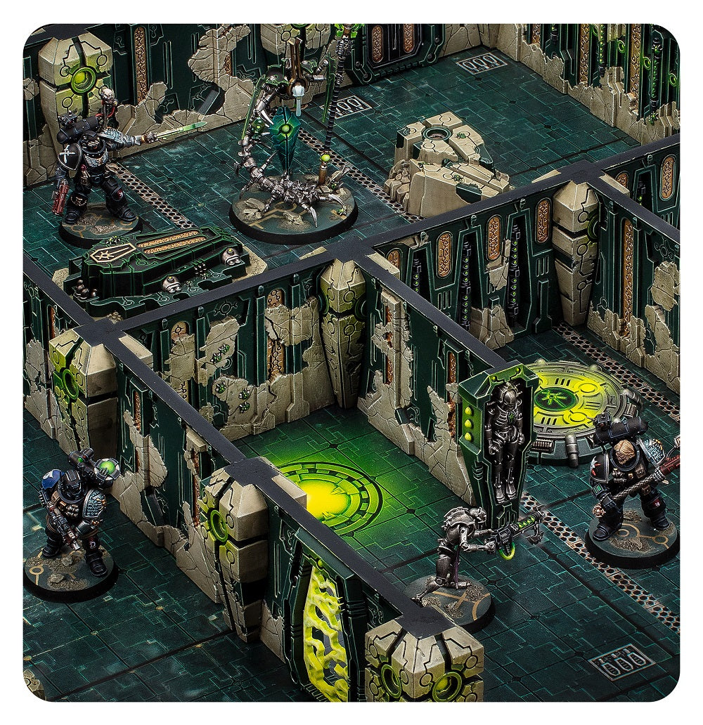 Miniature wargame scene featuring Space Marines and Necrons fighting in a ruined, neon-green Necron tomb complex