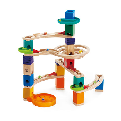 A complex, multi-level wooden marble run toy featuring colorful blocks, tracks, and several marbles in motion