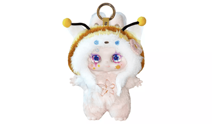Plush fuzzy doll keychain in a white and brown insect-themed costume with yellow antennae and large blue glitter eyes