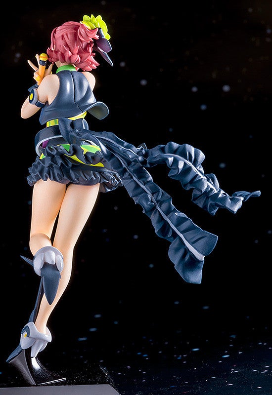 Anime figure of a girl wearing a dark gray and neon green outfit with a long flowing scarf