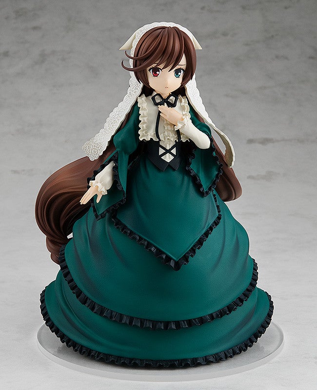 Anime figure of a woman in a flowing dark green Victorian dress with black ruffles white ruffled collar