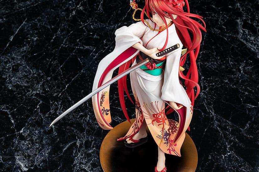 Anime figure of a girl with long red hair and white kimono holding a sword