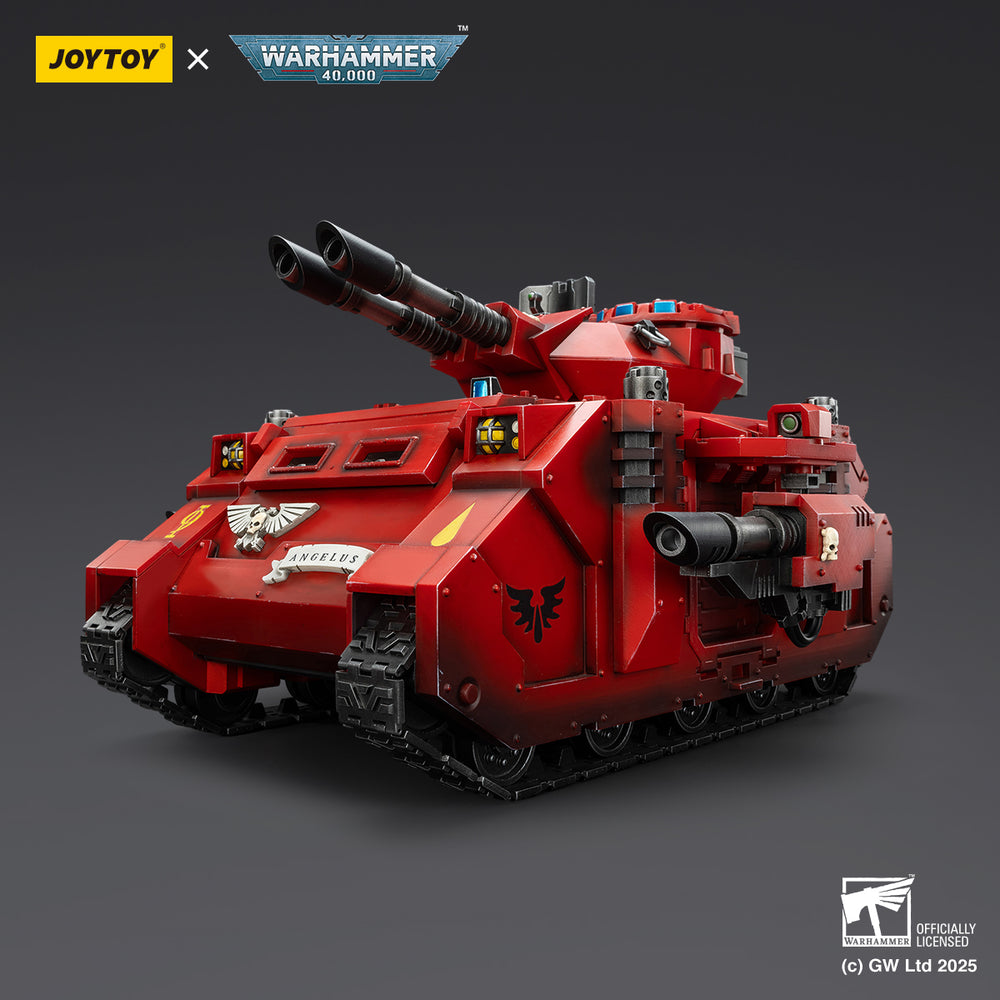 A red Joytoy Warhammer 40K tank model, featuring twin cannons, tracks, and Imperial insignias, on a dark background