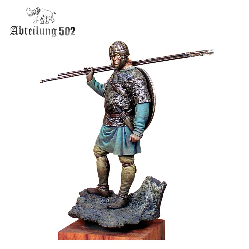 Detailed miniature of a medieval warrior in helmet and chainmail, carrying a spear over his shoulder and a shield on his back