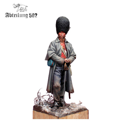 A detailed miniature Grenadier Guard Inkerman 1854 Figure wearing a tall fur hat, grey coat, and red uniform, holding a sword on a snowy base