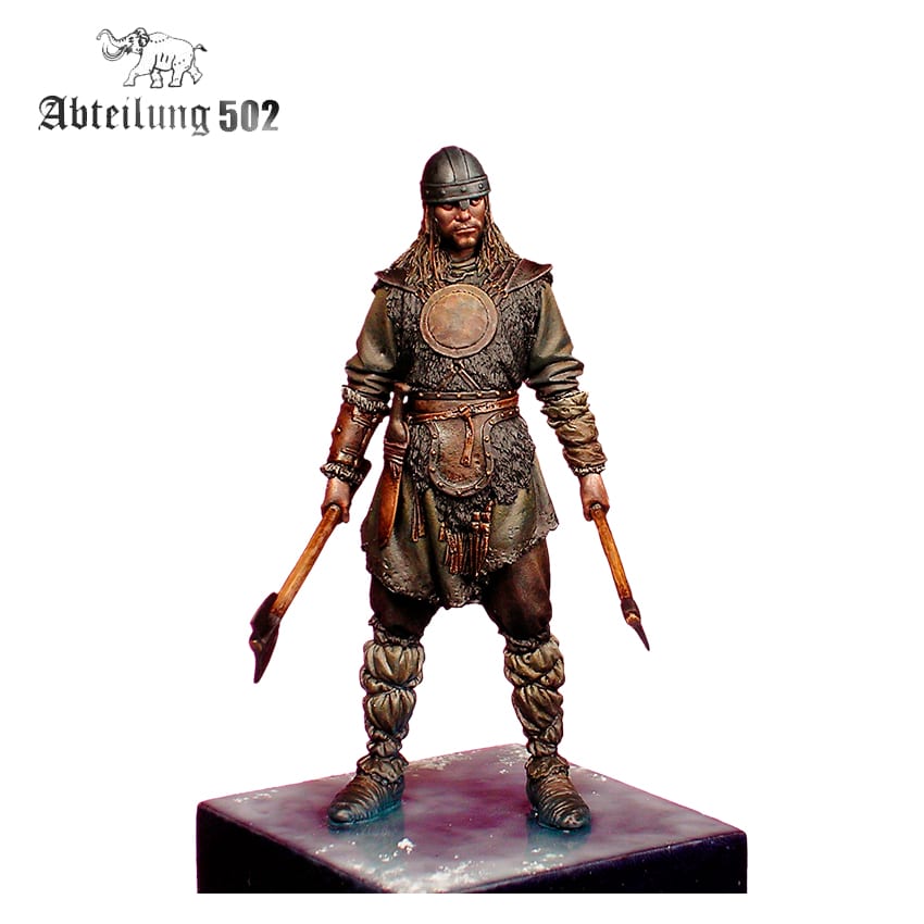A hand-painted miniature of a Viking warrior in a helmet and fur, holding two axes, standing on a base