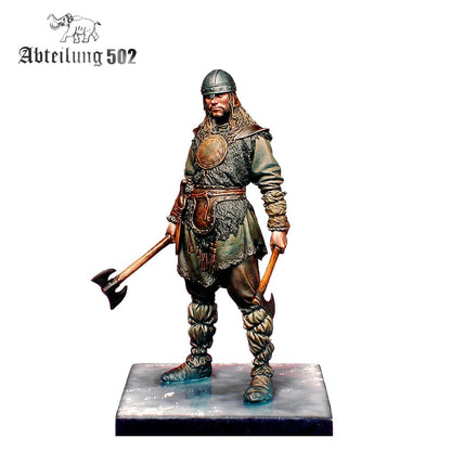 Scale model of a Viking warrior in a helmet and fur clothing, holding two battle axes