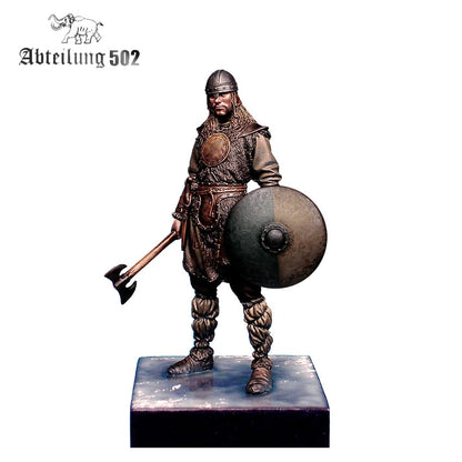 Miniature Viking warrior in helmet and armor, holding an axe and a round shield on a display base