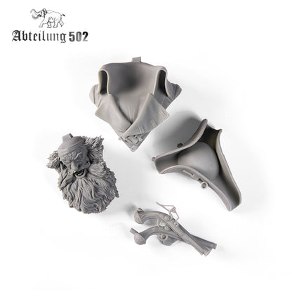 Unassembled gray model kit parts for a detailed pirate bust: bearded head, coat, tricorn hat, 2 flintlock pistols