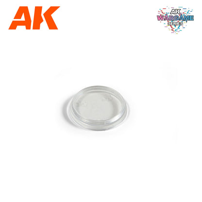 Clear -  round plastic wargame base with two small indentations on a white background