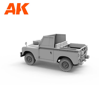Grey model of a classic open-top Land Rover pickup truck with a spare tire on the hood -  angled rear-right