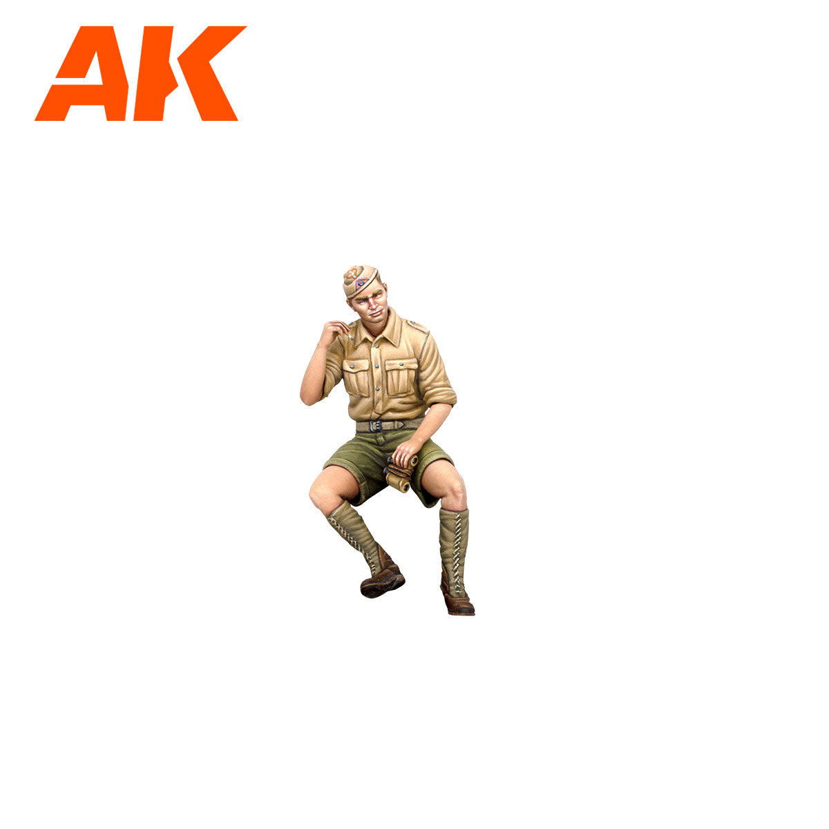 Scale model of a seated soldier in a tan uniform and green shorts -  holding binoculars